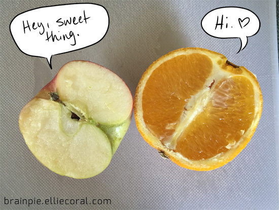 A half of an apple flirts with half of an orange. The apple says, 'Hey, sweet thing.' The orange replies, 'Hi, [heart symbol].'