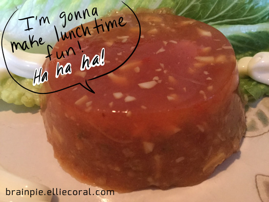 A disturbing closeup of the aspic, with its vegetable chunks-riddled form. It says menacingly, 'I'm gonna make lunchtime fun! Ha ha ha!'