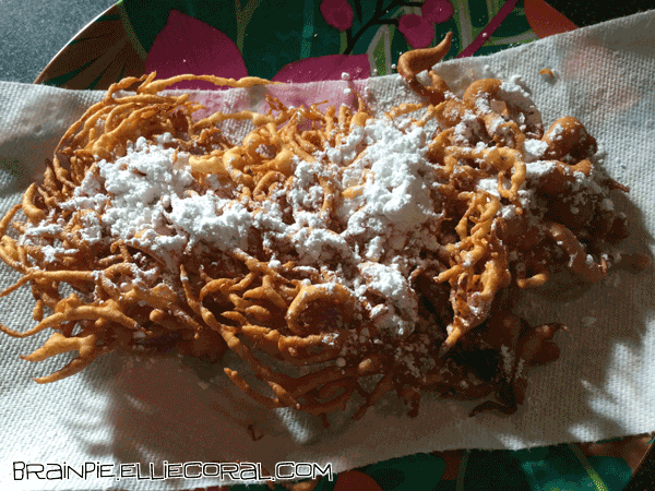 Both funnel cakes topped with powdered sugar.