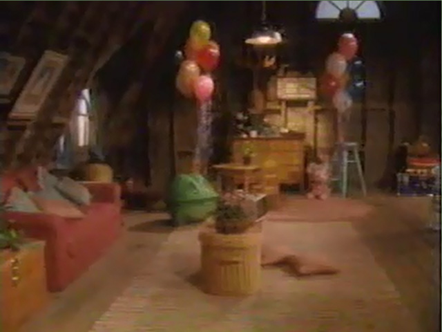 The attic has been cleaned up, currently featuring a couch, a desk, a dresser, and balloons.