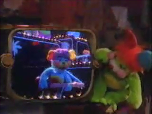 Putter watches a TV that has the earlier Popples song playing on it.