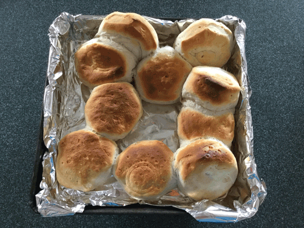 The same carelessly tossed biscuits now cooked to an uneven brown.