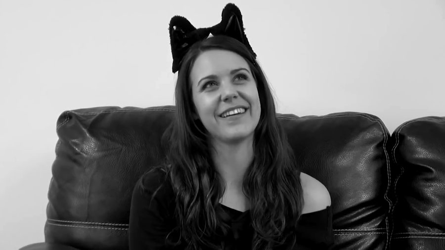 Rebecca wears costume cat ears.